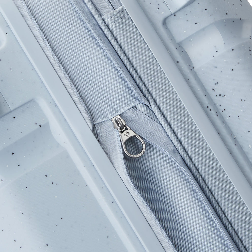 Samsonite Outline Pro Spinner Medium in the color Translucent Blue.
