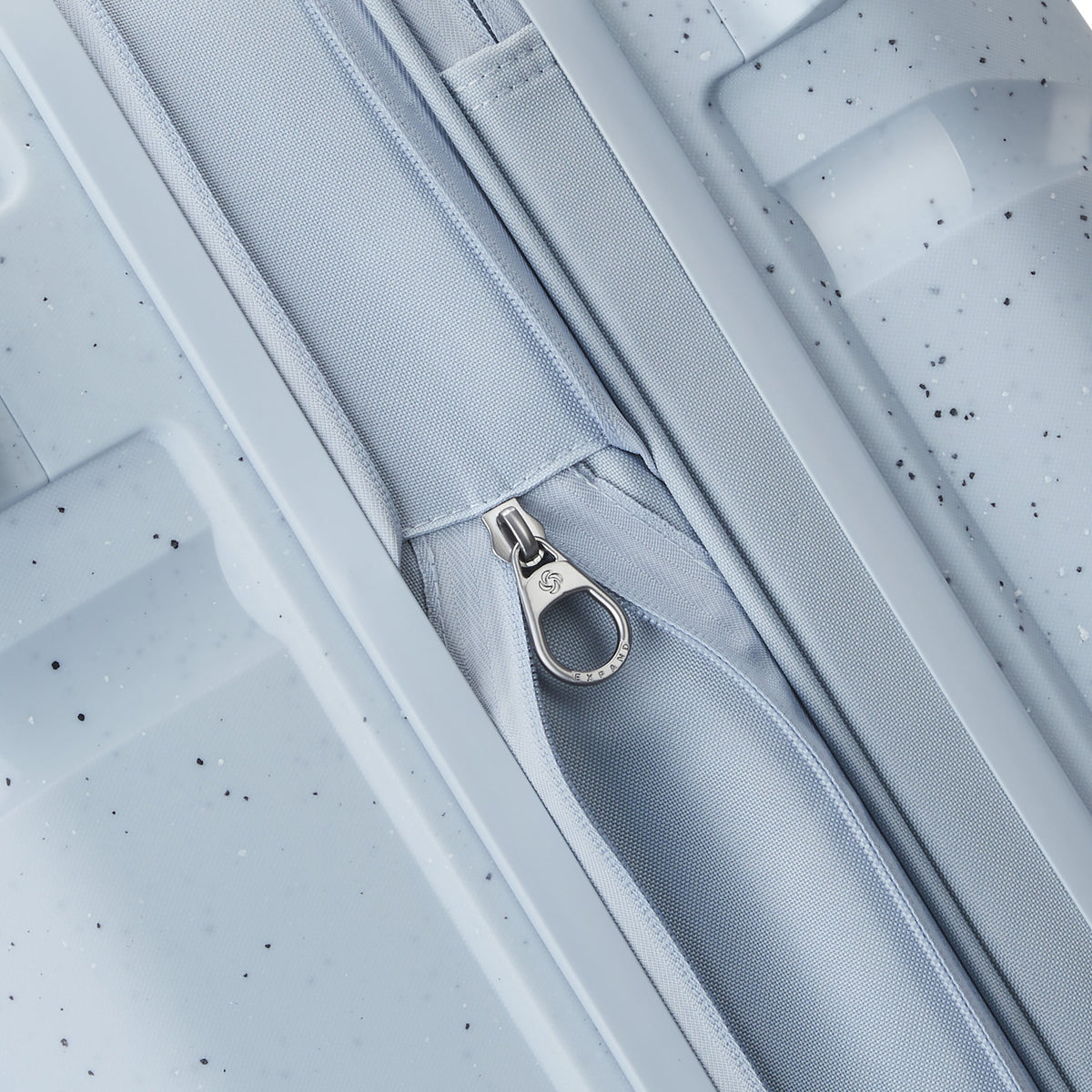 Samsonite Outline Pro Spinner Medium in the color Translucent Blue.