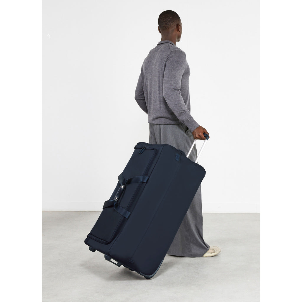 Lipault Foldable Plume Wheeled Duffle (78/29) in the color Midnight Blue.