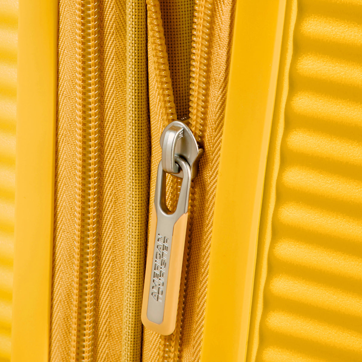 American Tourister Curio Spinner Large in the color Golden Yellow.